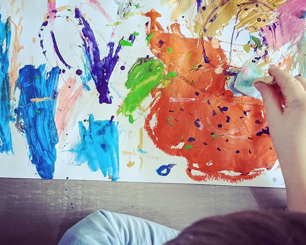 enfant qui peint avec des glaçons