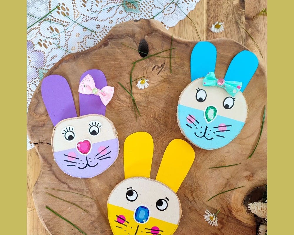 De jolis lapins peints sur des rondins de bois
